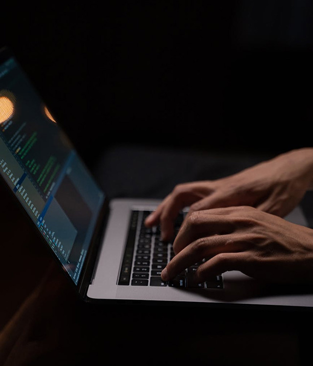 Close-up of fingers lyping on a laptop
