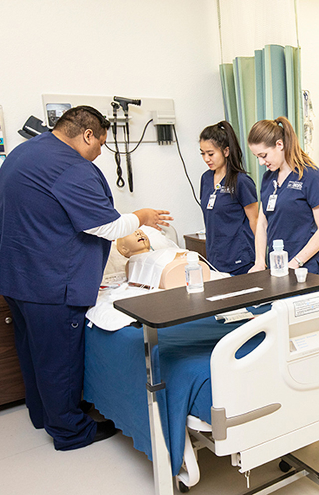 Person demonstrating a medical exam on a dummy