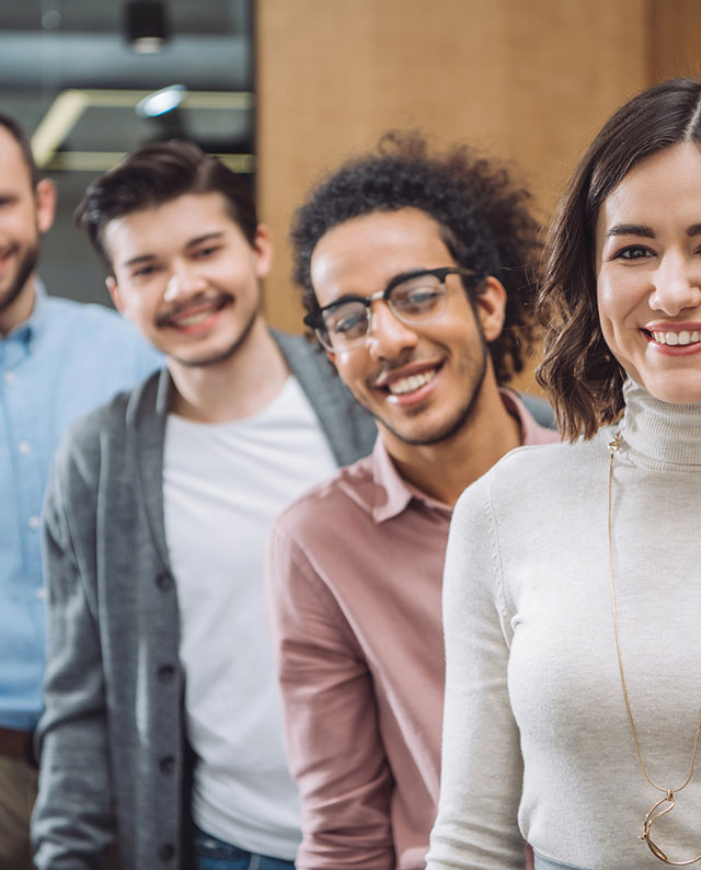 Group of young adults smiling at the camera