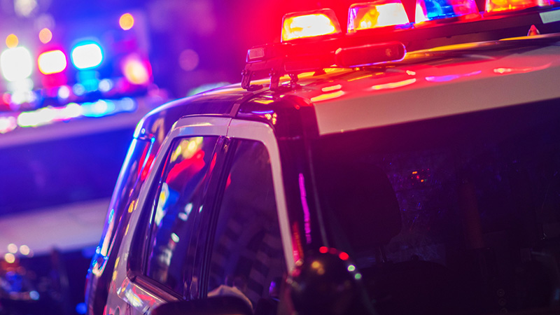 Police vehicles at night with flashing lights