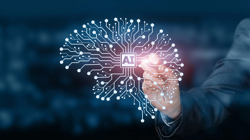 A hand interacting with a glowing digital circuit board shaped like a human brain with "AI" in the center.