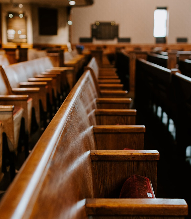 Empty wooden benches in a courtroom