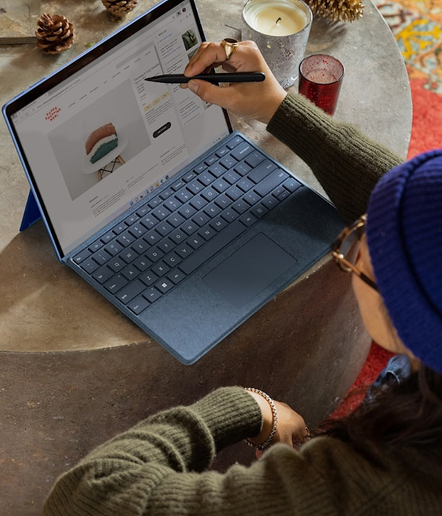 Person using a stylus on a laptop screen